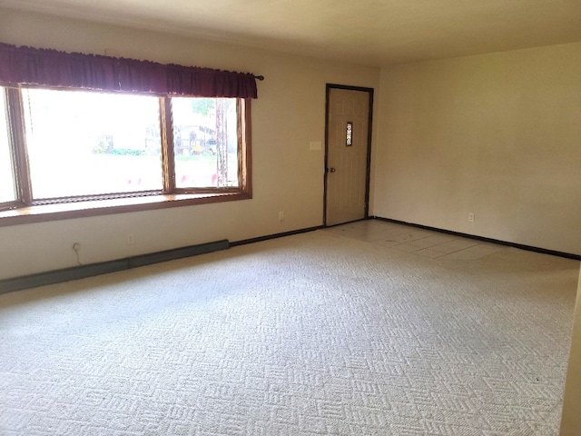 spare room featuring light colored carpet