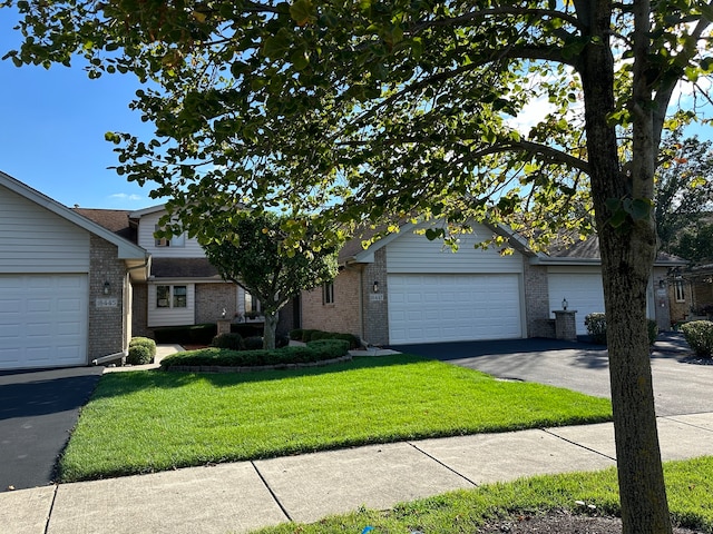 single story home with a garage and a front lawn