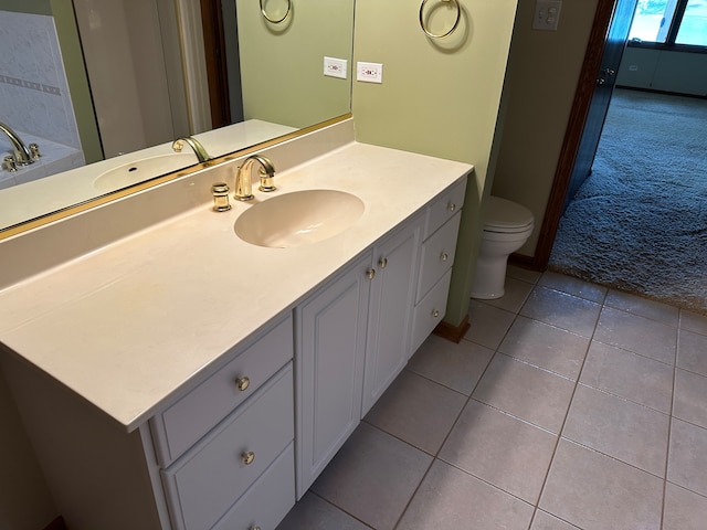 bathroom with vanity, tile patterned flooring, and toilet