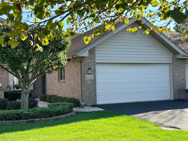 view of front of home featuring a front yard and a garage