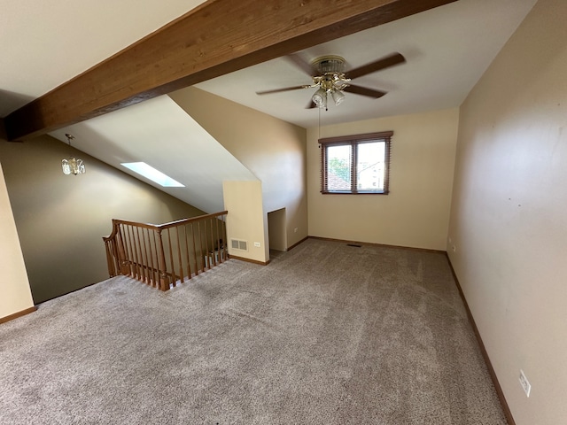 bonus room with ceiling fan, light colored carpet, and vaulted ceiling with skylight