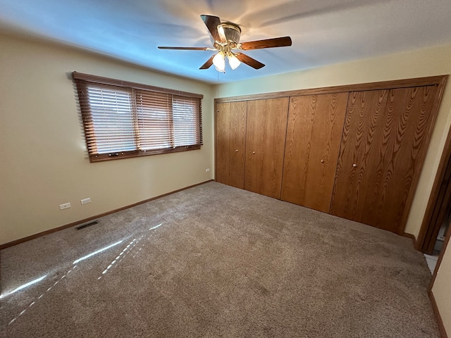 unfurnished bedroom featuring carpet floors, ceiling fan, and a closet