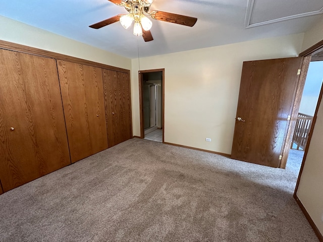 unfurnished bedroom with ceiling fan, light colored carpet, and a closet