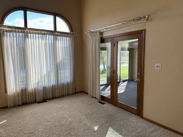 carpeted spare room with french doors