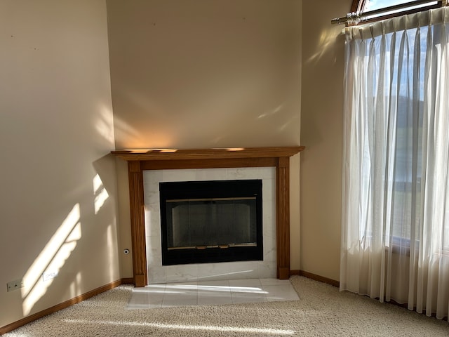 details with a tile fireplace and carpet floors