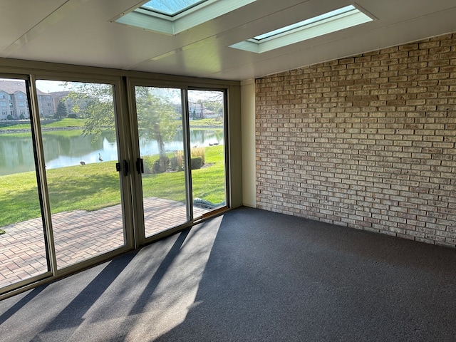 unfurnished sunroom featuring a wealth of natural light and a water view