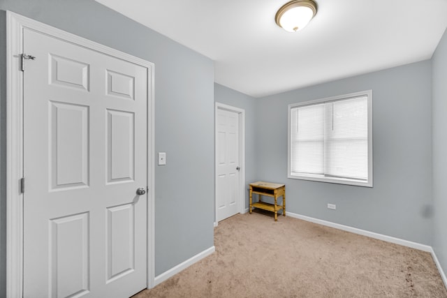 unfurnished bedroom featuring light carpet