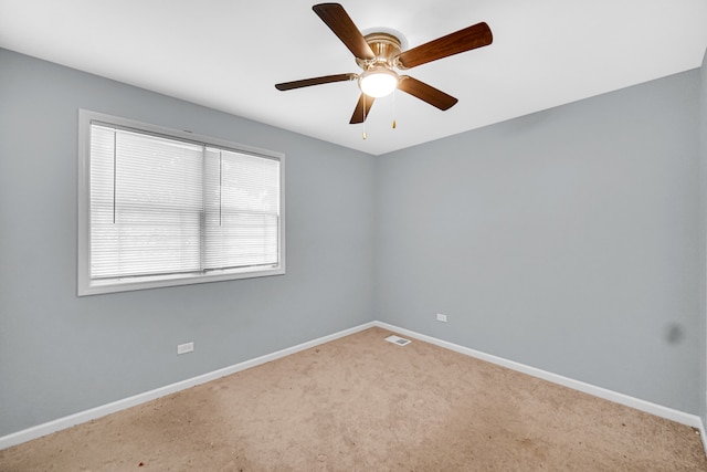 carpeted spare room featuring ceiling fan