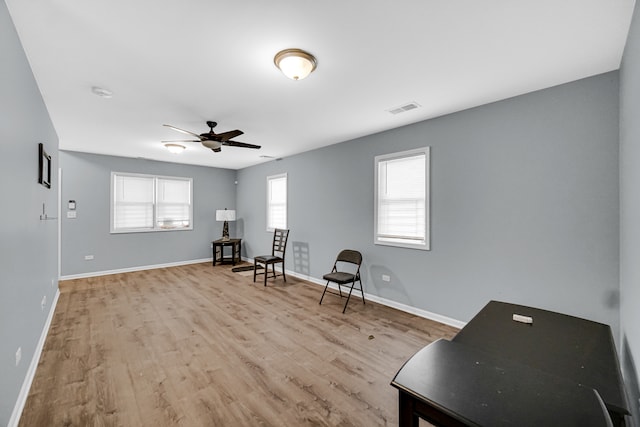 unfurnished room featuring light wood-type flooring, a healthy amount of sunlight, and ceiling fan