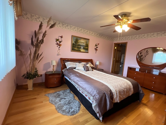 bedroom with light hardwood / wood-style flooring and ceiling fan