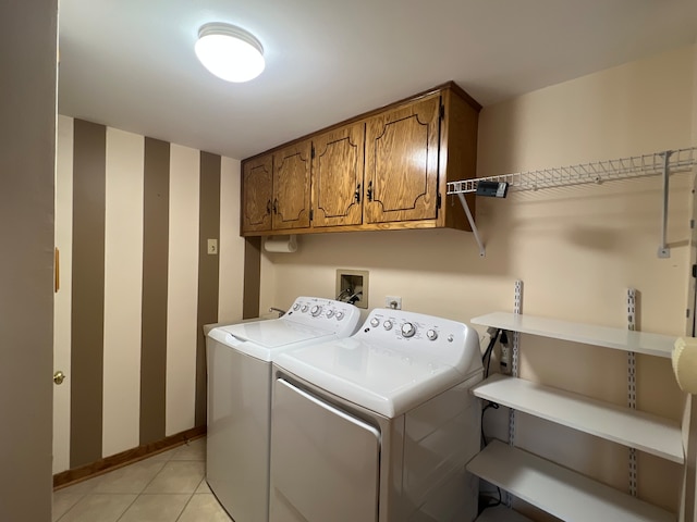 washroom featuring cabinets, independent washer and dryer, and light tile patterned floors