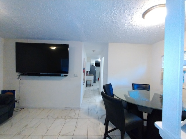 dining area featuring a textured ceiling