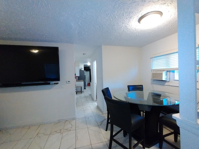 dining room featuring cooling unit and a textured ceiling