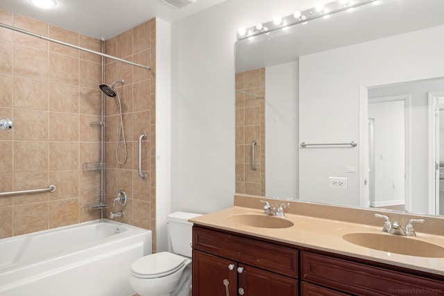 full bathroom featuring vanity, toilet, and tiled shower / bath