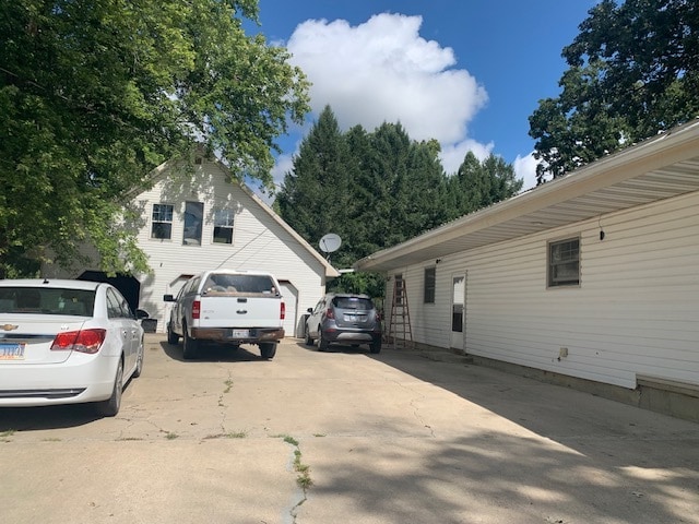 view of side of home featuring a garage