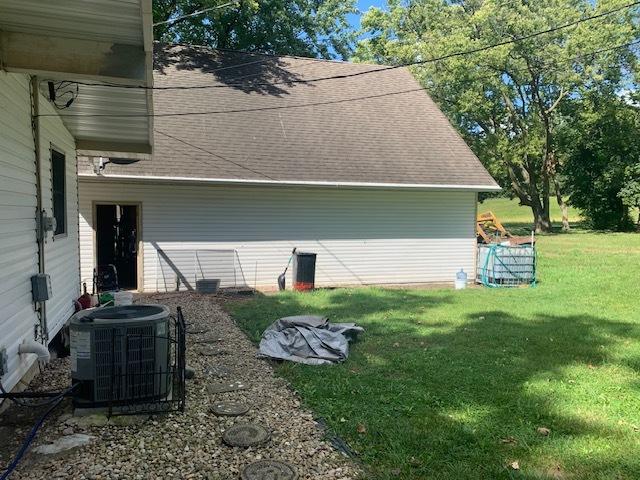 1901 Chestnut St, Ottawa, IL 61350 - view of property exterior featuring central AC, a yard, and roof with shingles