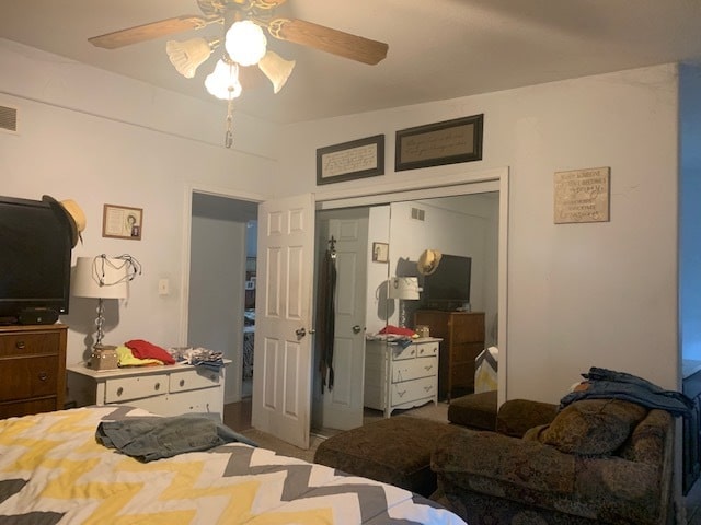 bedroom with ceiling fan and a closet