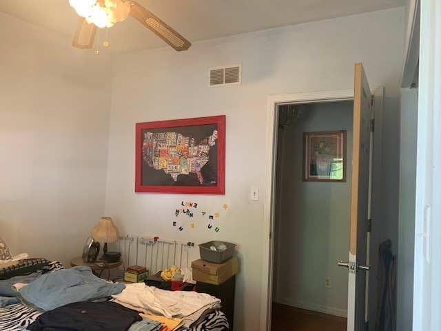 bedroom featuring radiator heating unit and ceiling fan