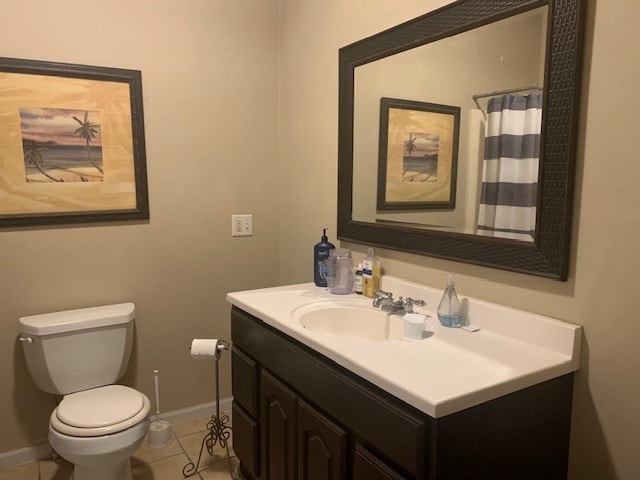 bathroom with tile patterned floors, vanity, and toilet