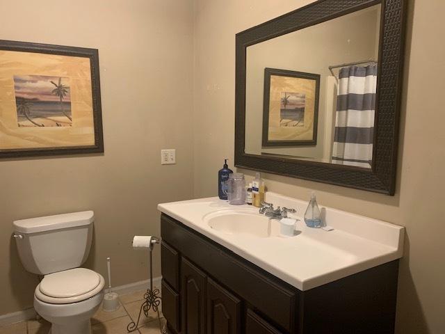 1901 Chestnut St, Ottawa, IL 61350 - bathroom with toilet, vanity, tile patterned floors, and baseboards
