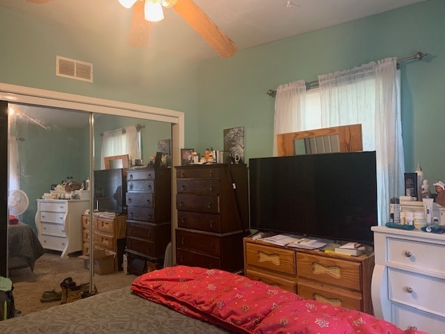 carpeted bedroom with a closet and ceiling fan