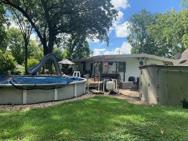 1901 Chestnut St, Ottawa, IL 61350 - rear view of property featuring a lawn and a covered pool