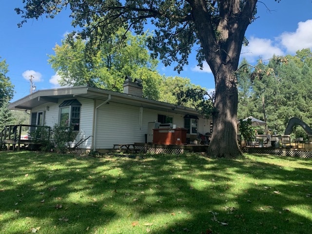 exterior space with a deck and a yard