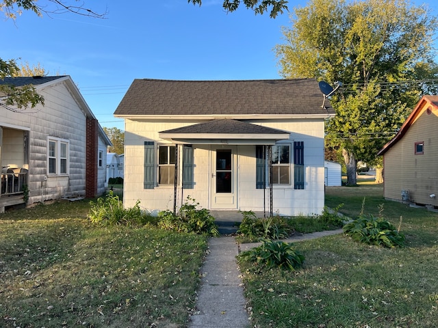 bungalow-style house featuring a front yard