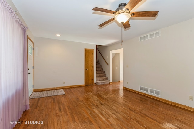 spare room with ceiling fan and wood-type flooring