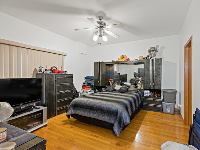 bedroom with ceiling fan and hardwood / wood-style flooring