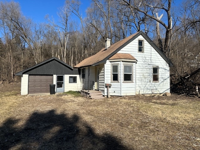 view of front of house featuring an outdoor structure and a garage