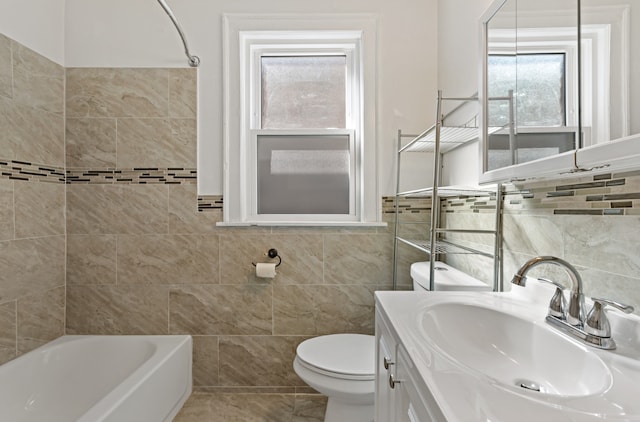 full bathroom with tile walls, shower / bath combination, tile patterned floors, vanity, and toilet