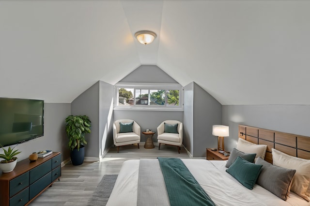 bedroom featuring light hardwood / wood-style flooring and vaulted ceiling