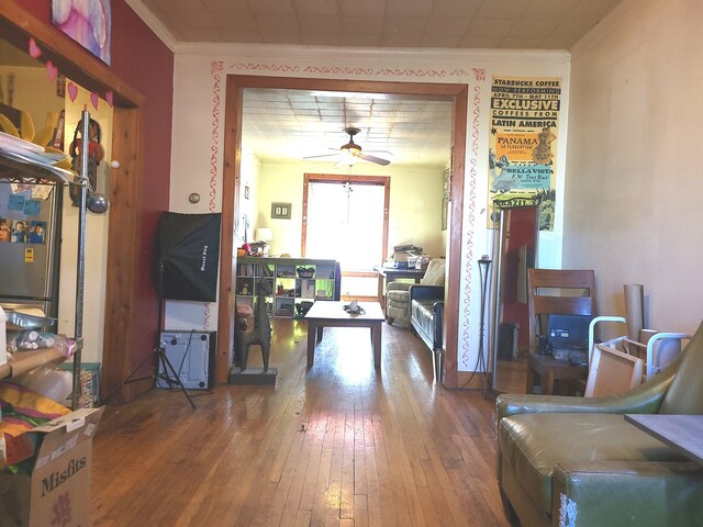 entrance foyer with crown molding, ceiling fan, and hardwood / wood-style flooring