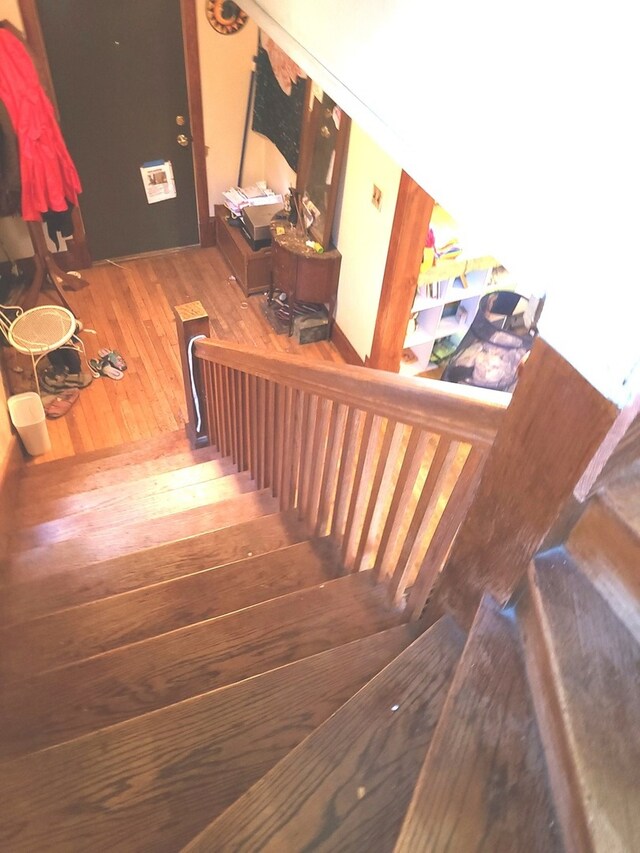 stairs featuring wood-type flooring