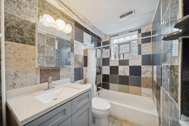 full bathroom with vanity, tile walls, shower / tub combo, and toilet