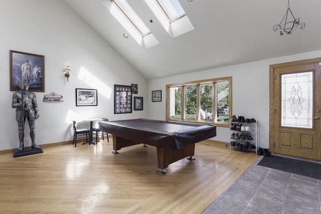 rec room with high vaulted ceiling, light wood-style flooring, baseboards, billiards, and a skylight