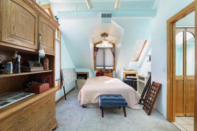 carpeted bedroom featuring a closet, a skylight, and ceiling fan