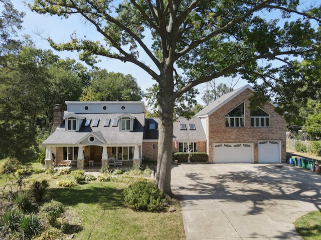 view of front facade with a front lawn, a garage, and covered porch