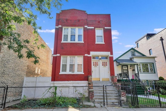 2333 W Huron St, Chicago, IL 60612 - view of front of property with brick siding, a fenced front yard, and a gate