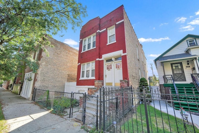 2333 W Huron St, Chicago, IL 60612 - view of front of property with covered porch, brick siding, a gate, and a fenced front yard