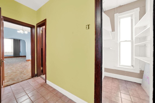 2333 W Huron St, Chicago, IL 60612 - hall featuring plenty of natural light, light colored carpet, arched walkways, and an inviting chandelier