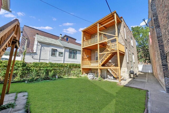 2333 W Huron St, Chicago, IL 60612 - back of property featuring fence, a wooden deck, stairs, a yard, and a patio area