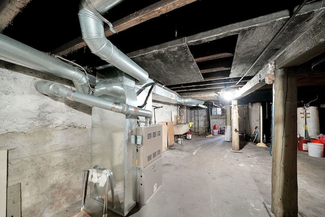 basement featuring water heater and sink