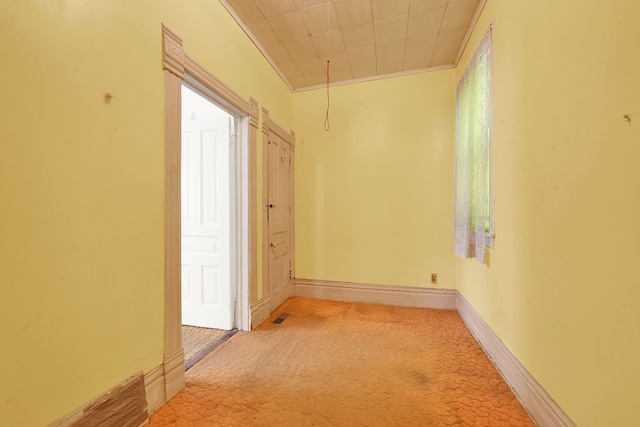 hall featuring crown molding and light carpet