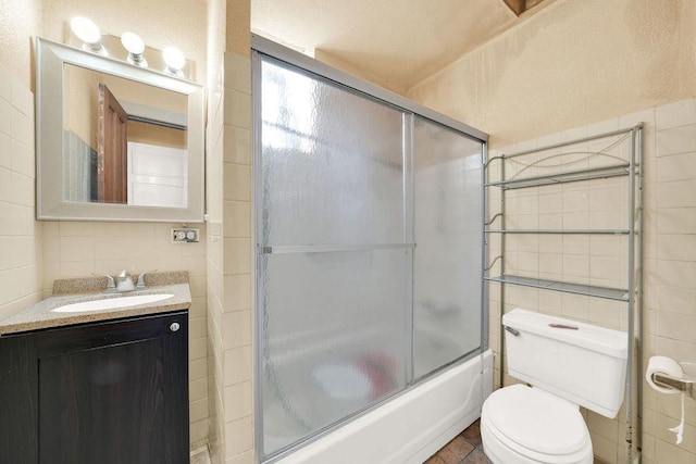 2333 W Huron St, Chicago, IL 60612 - bathroom with tile walls, toilet, shower / bath combination with glass door, and vanity