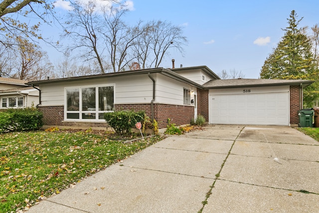 single story home featuring a garage and a front yard