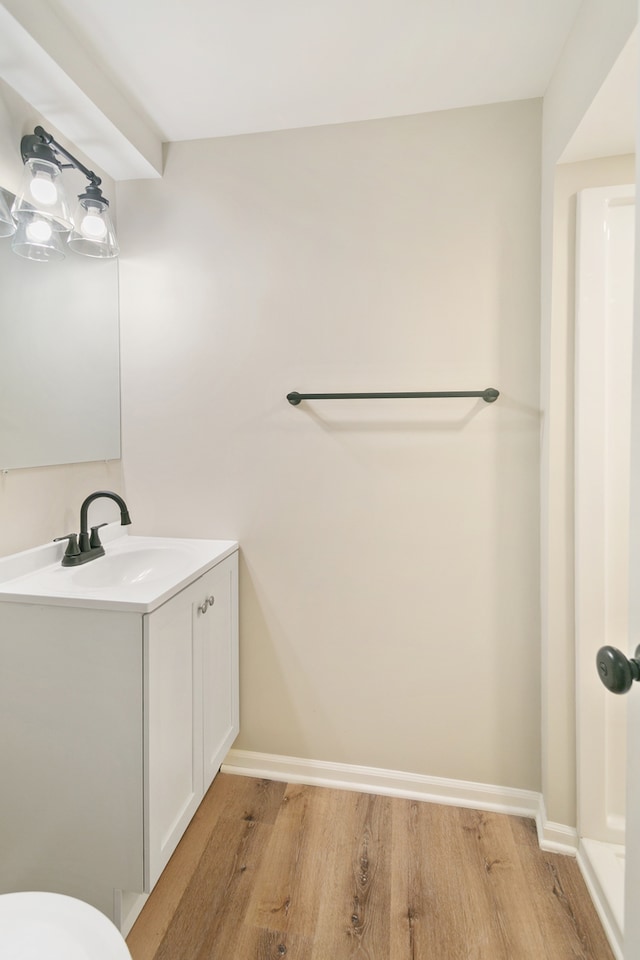 bathroom with hardwood / wood-style floors and vanity