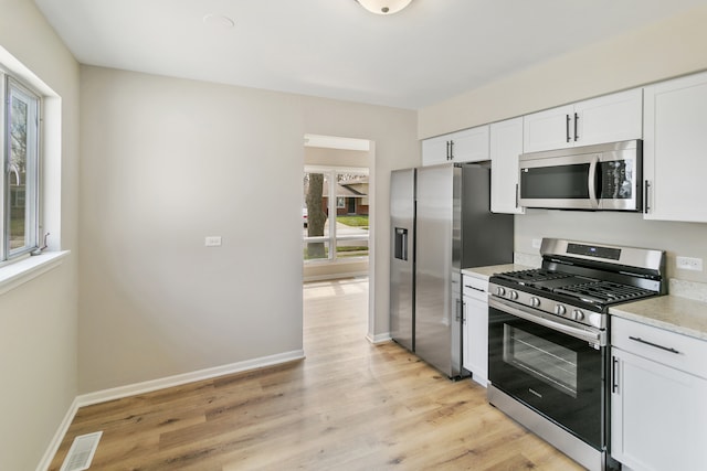 kitchen featuring light hardwood / wood-style floors, white cabinetry, and stainless steel appliances