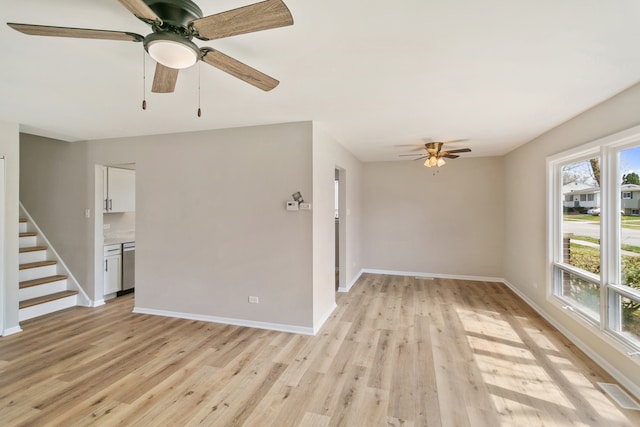 spare room featuring light hardwood / wood-style flooring and ceiling fan